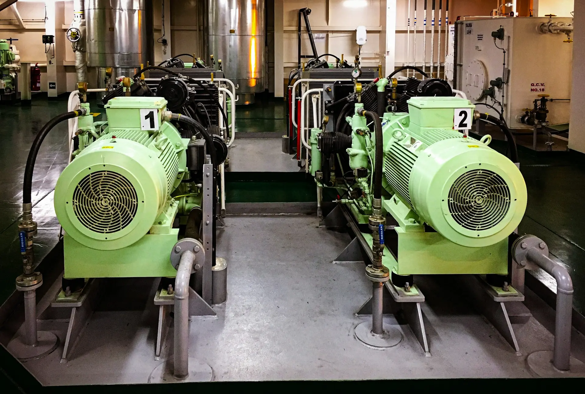 a couple of green machines sitting inside of a building